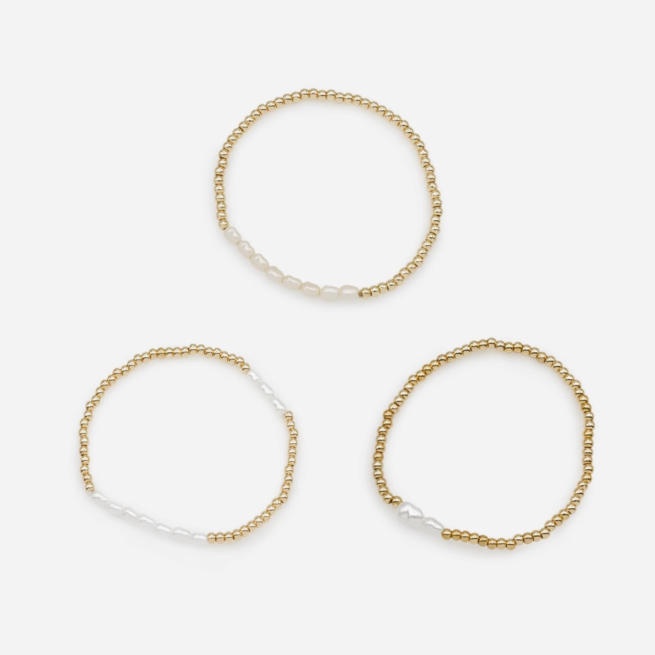 Trio de bracelets élastiques dorés perle synthétique trois façons
