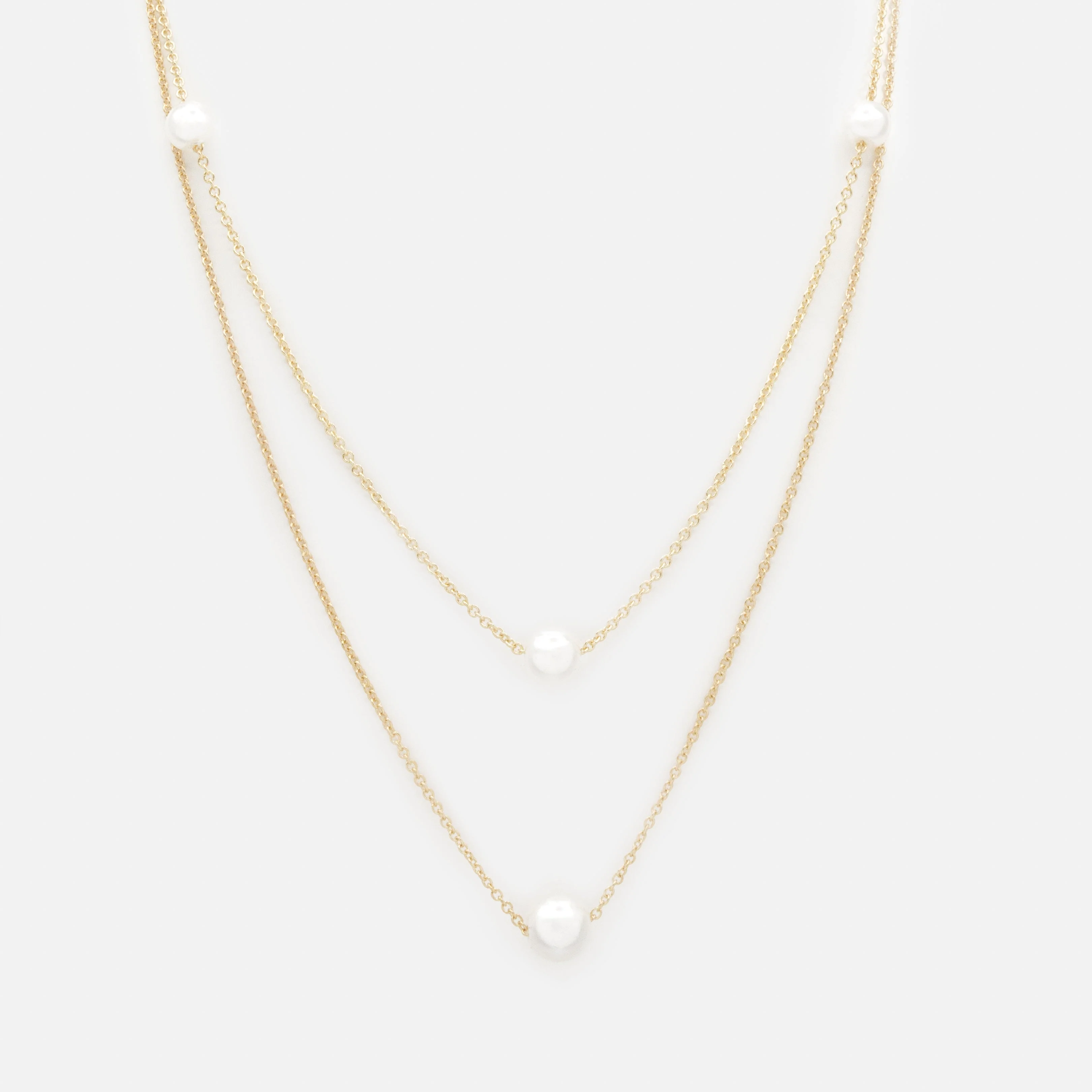 Collier doré double chaîne avec perles rondes
