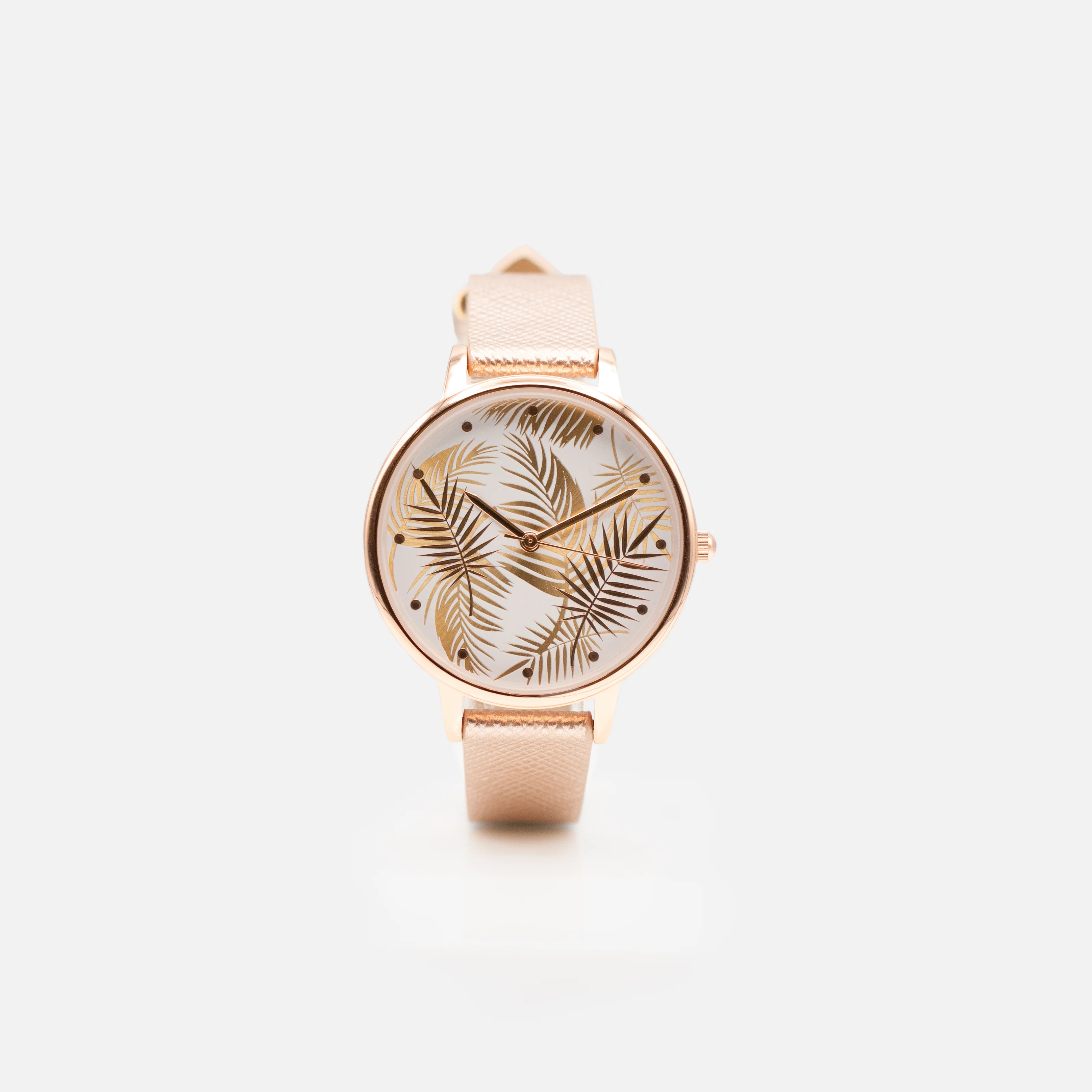 Montre rose doré cadran rond avec fond feuilles de palmier