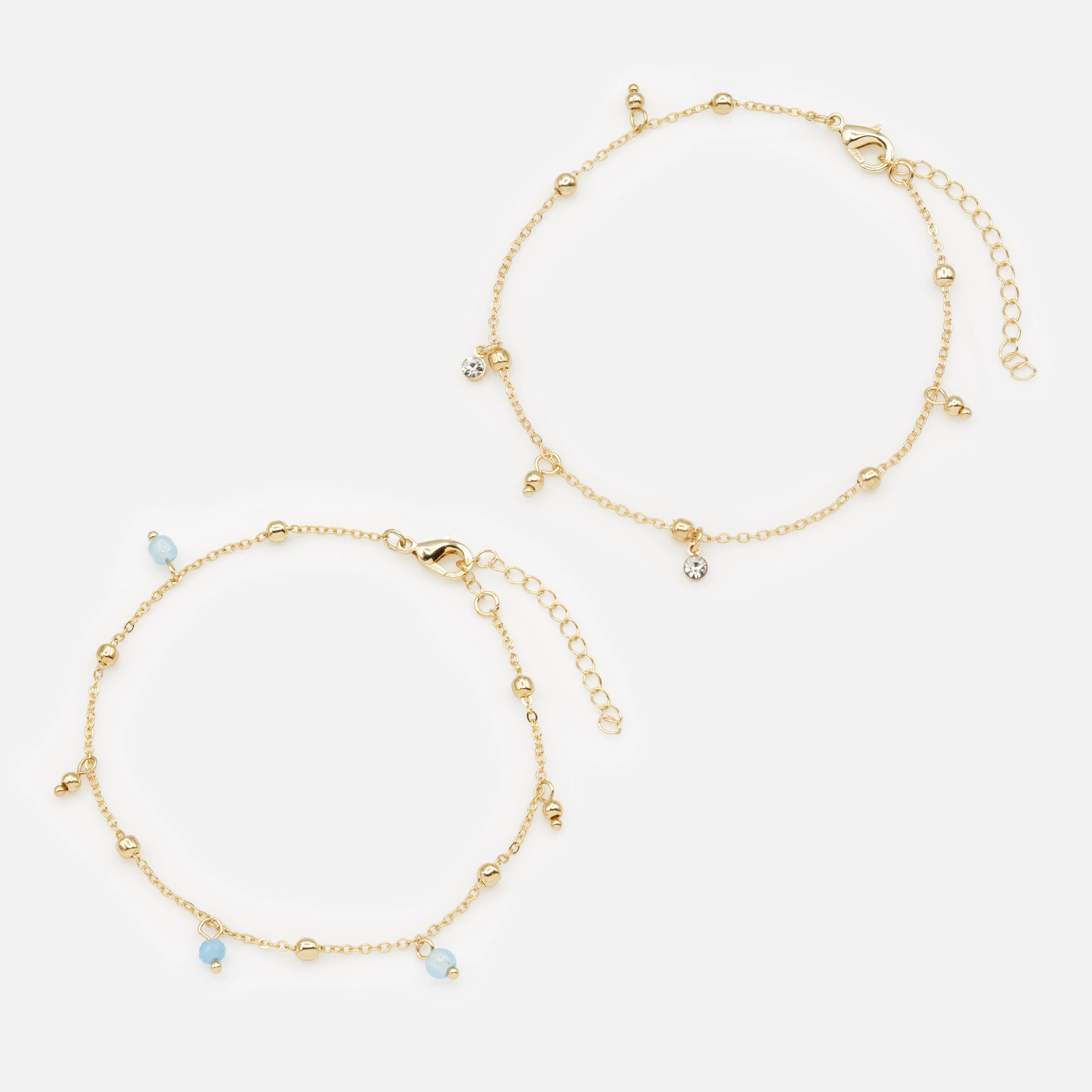 Duo chaînes de cheville dorées billes bleues